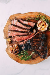 Igotchu Steak Seasoning container with a close-up of seasoned grilled steak on a plate, highlighting flavor and spice blend.
