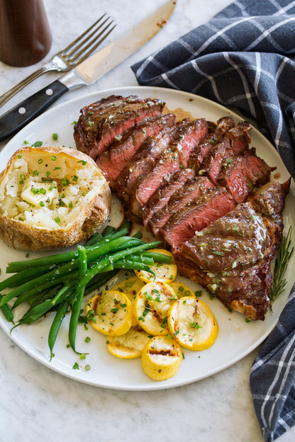 Igotchu Steak Seasoning jar with seasoning blend for enhancing grilled and cooked steaks, shown on a rustic wooden surface.