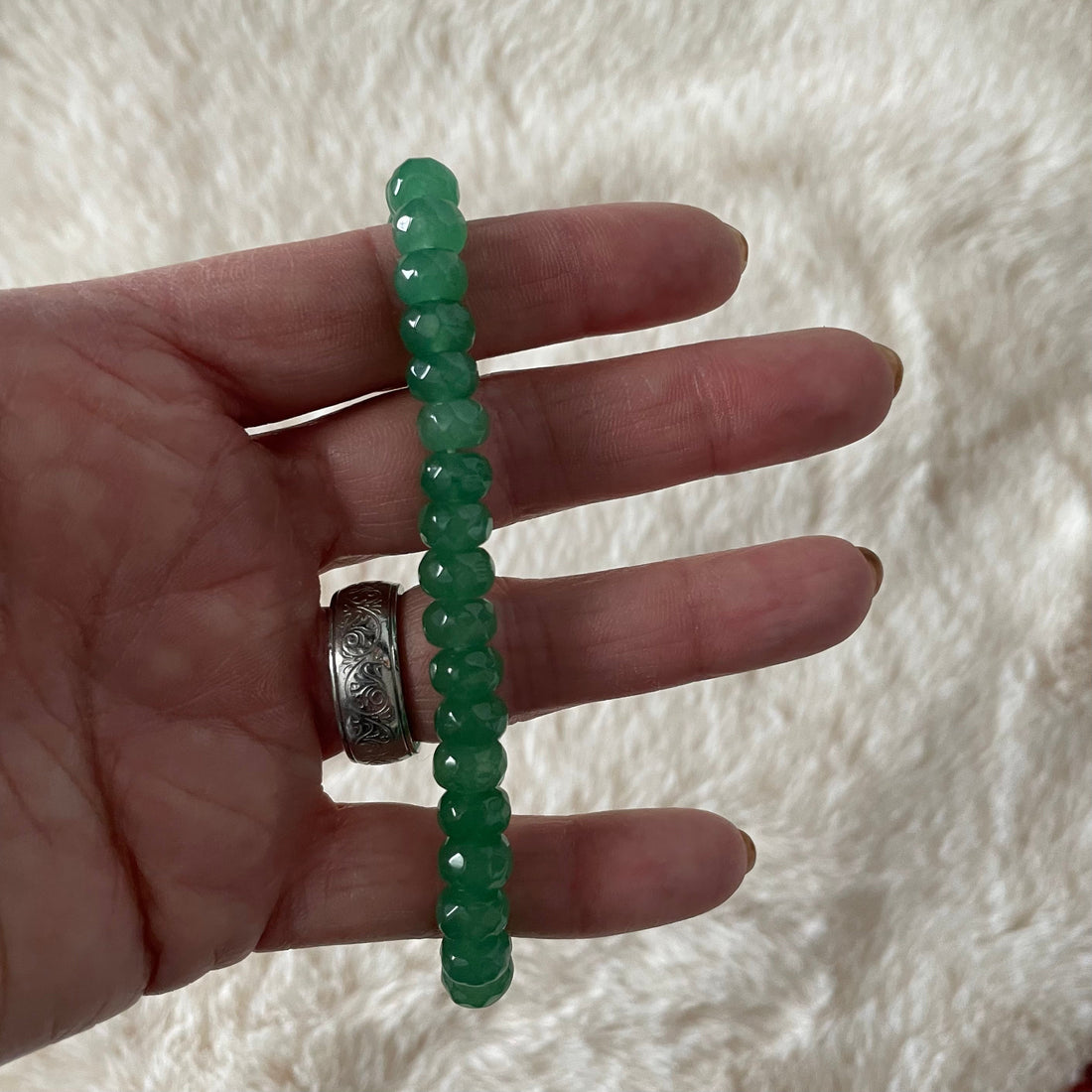 Faceted rondelle beaded bracelet by Evermore Everlasting featuring shimmering multi-colored beads on a stretchy elastic band.