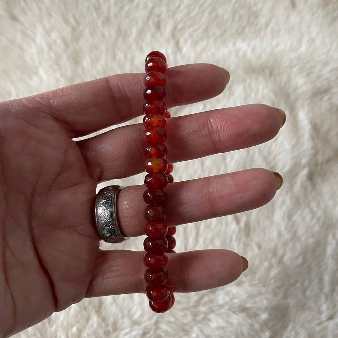 Faceted rondelle beaded bracelet by Evermore Everlasting featuring shiny, multicolored glass beads on a stretchy elastic band.