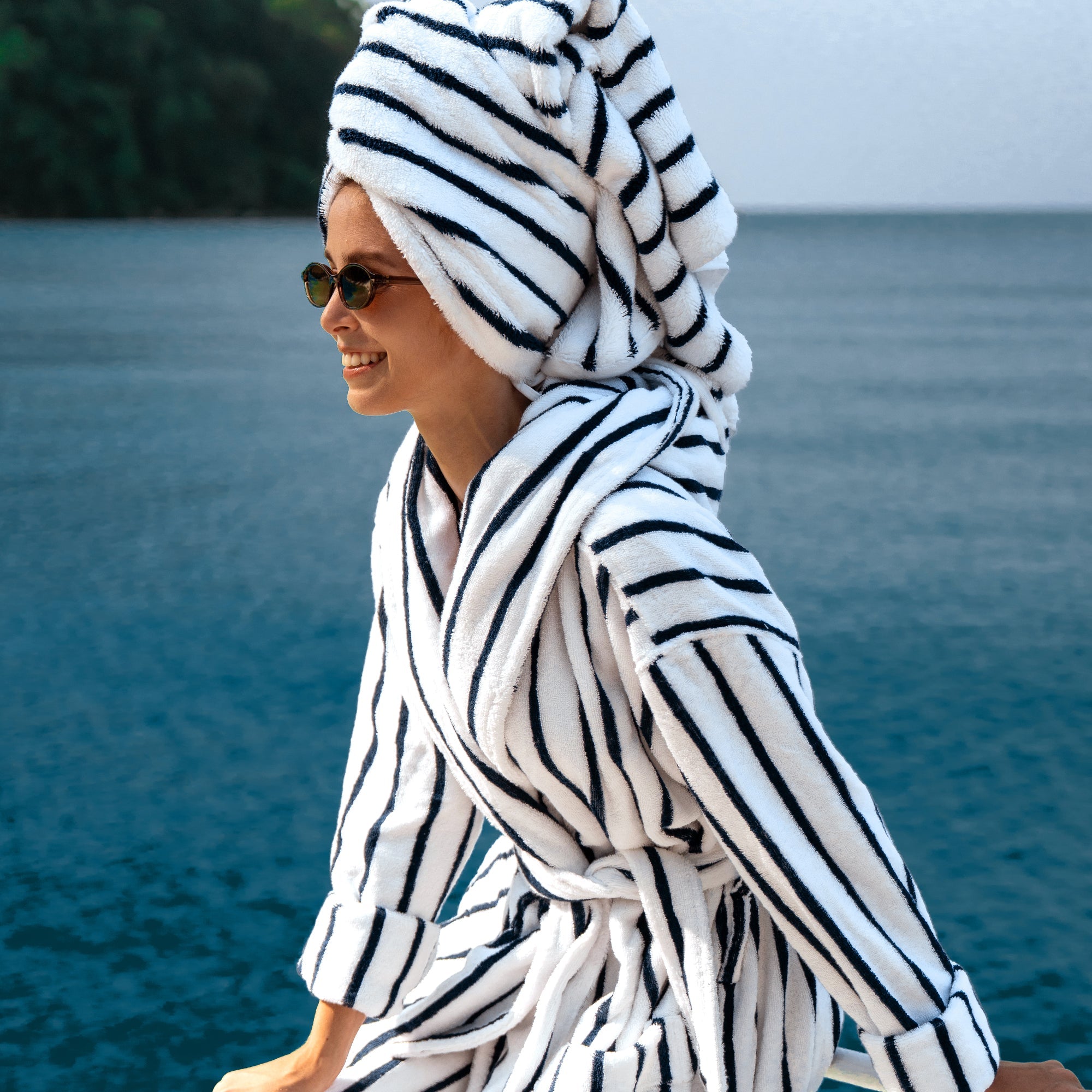 Unisex Ultraplush Australian Cotton Bathrobe by Italic displayed with matching towels in a cozy setting.