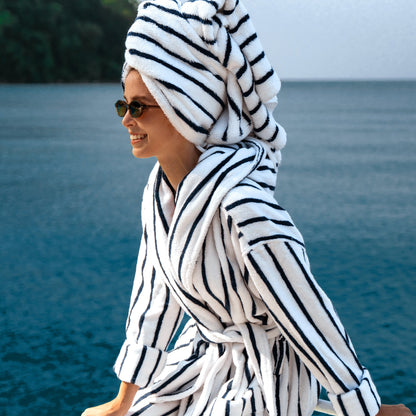 Unisex Ultraplush Australian Cotton Bathrobe by Italic displayed with matching towels in a cozy setting.