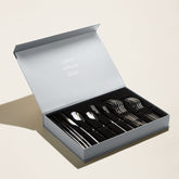 Italic Emilia Mirror 20-piece flatware set with polished stainless steel forks, knives, spoons, and teaspoons displayed on a white background.