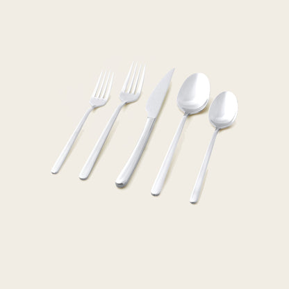 Italic Emilia Mirror 20-piece flatware set with sleek silver finish, including forks, knives, spoons, and serving utensils.