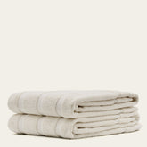 Soft Capri Australian Cotton bath towel from Italic, shown folded with textured white fabric and subtle striped design.