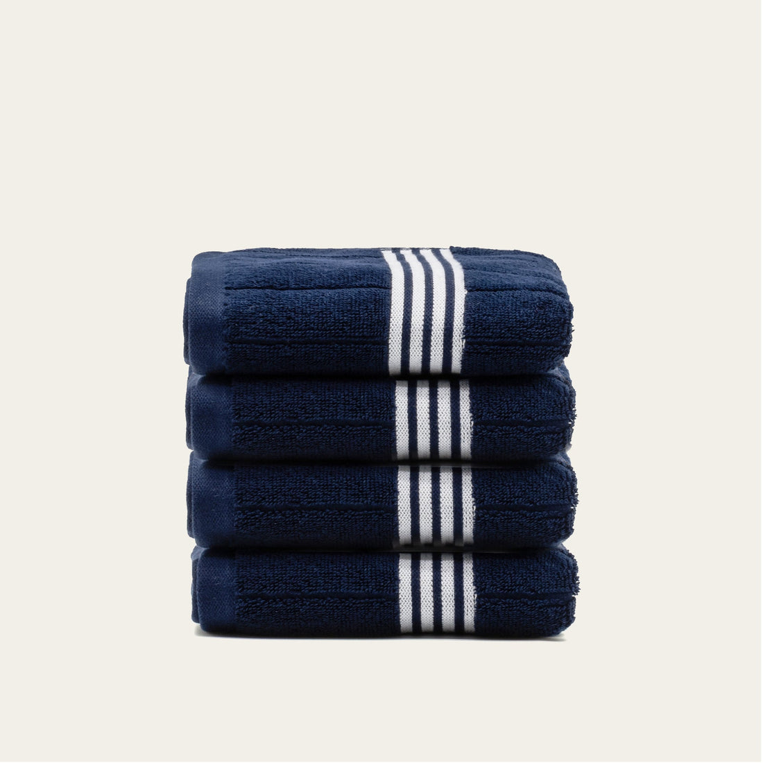 Nautilus Australian Cotton hand towel by Italic, soft and plush bath towel with white and blue stripes, hanging on a towel rack.