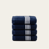 Nautilus Australian Cotton hand towel by Italic, soft and plush bath towel with white and blue stripes, hanging on a towel rack.