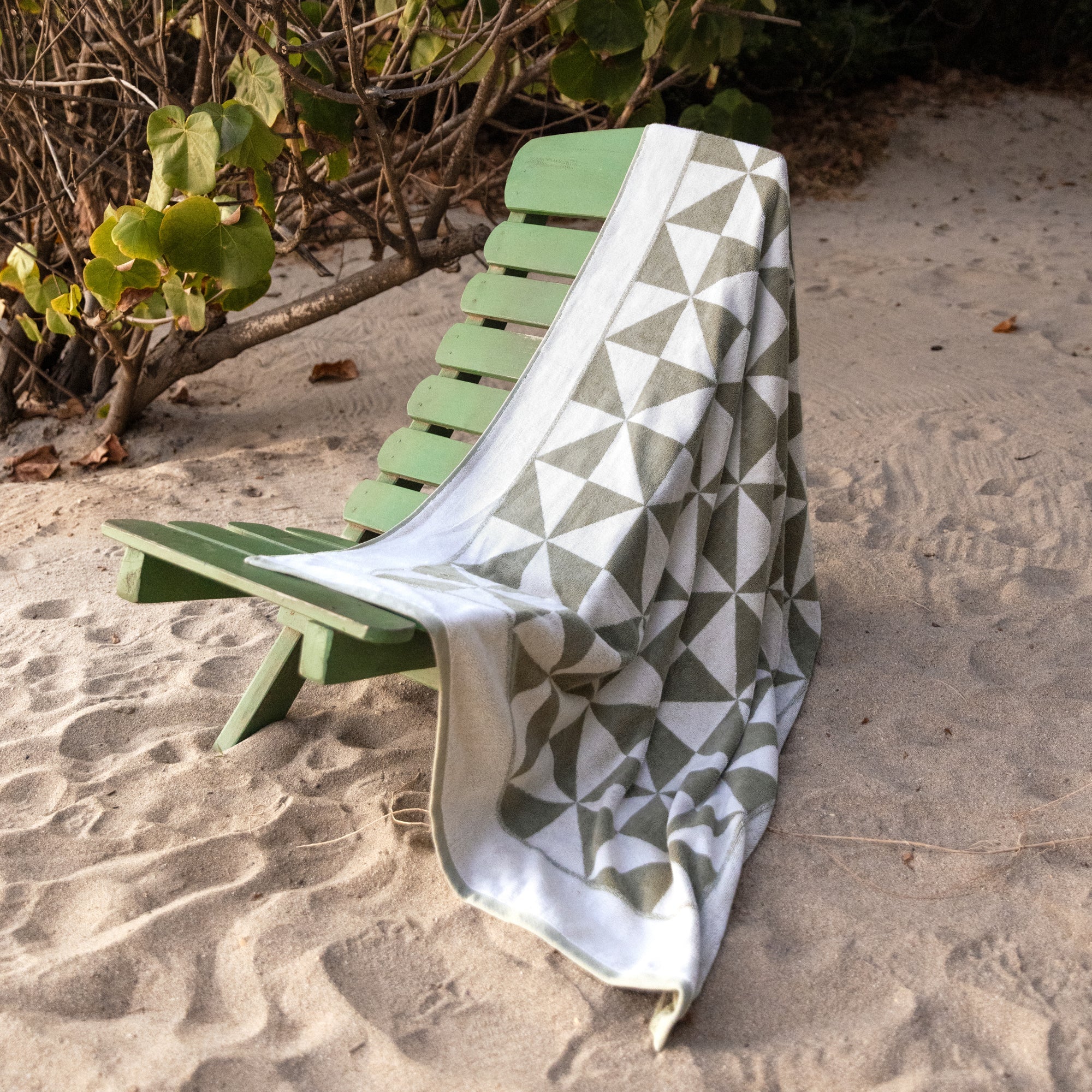 Soft white Umbra Australian Cotton Bath Towel by Italic, folded on a wooden surface, showcasing plush texture and high absorbency.