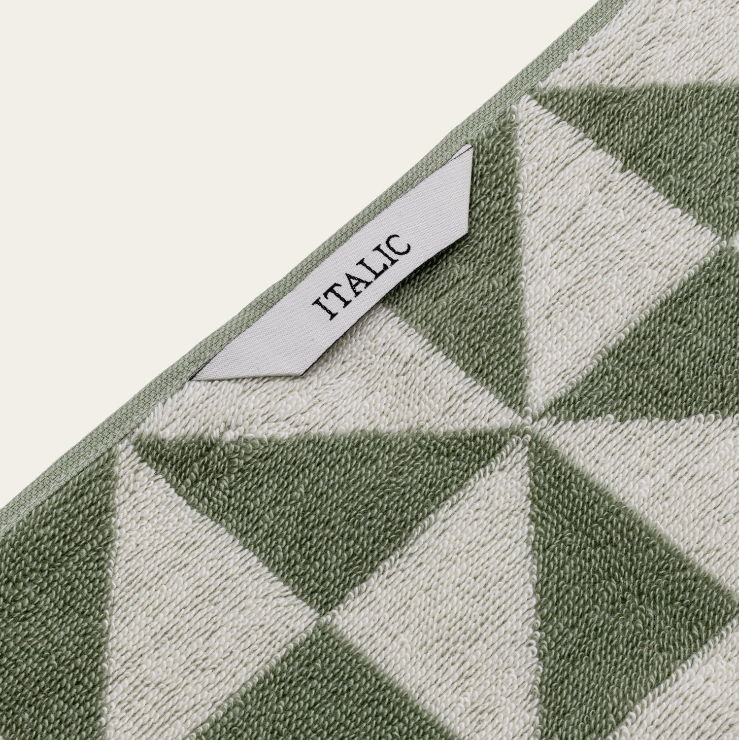 Italic Umbra Australian Cotton Bath Towel set with soft, plush white towels hanging on a bathroom rack.