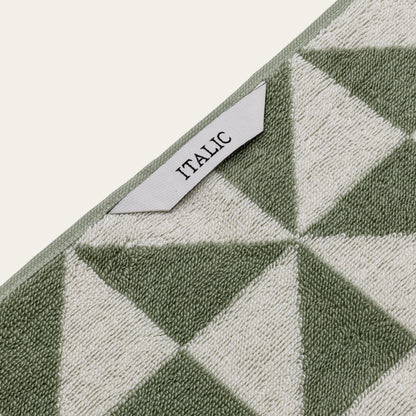 Italic Umbra Australian Cotton Bath Towel set with soft, plush white towels hanging on a bathroom rack.