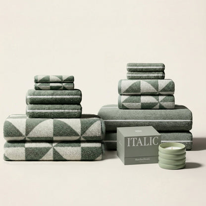 White Umbra Australian cotton bath towel from Italic, folded neatly on a bathroom countertop, showcasing soft, plush texture.