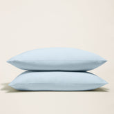 Italic Luxe Australian Sateen Pillowcase Set shown on bed, soft, smooth satin fabric in elegant pillow arrangement.