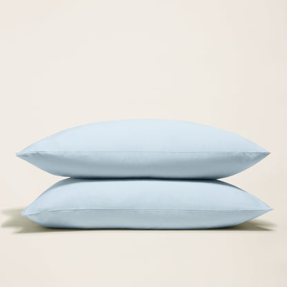 Italic Luxe Australian Sateen Pillowcase Set shown on bed, soft, smooth satin fabric in elegant pillow arrangement.