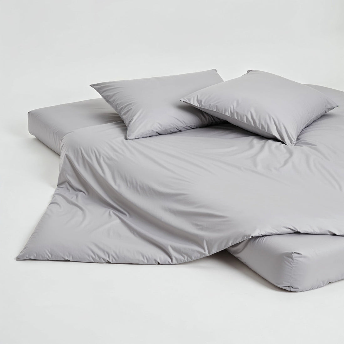 Elegant set of Luxe Australian Sateen pillowcases from Italic, showcasing smooth, shiny fabric on a neatly made bed.