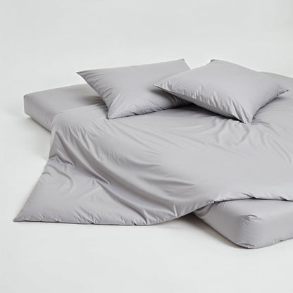 Elegant set of Luxe Australian Sateen pillowcases from Italic, showcasing smooth, shiny fabric on a neatly made bed.