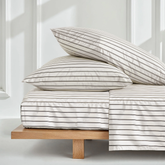 Black and ecru mini stripe satin sheet set by Italic, showcasing smooth, luxurious Australian sateen bed sheets on a neatly made bed.