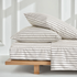 Black and ecru mini stripe satin sheet set by Italic, showcasing smooth, luxurious Australian sateen bed sheets on a neatly made bed.