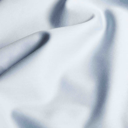 Soft Luxe Australian Sateen Sheet Set by Italic on a bed with smooth, shiny satin fabric in a cozy bedroom setting.