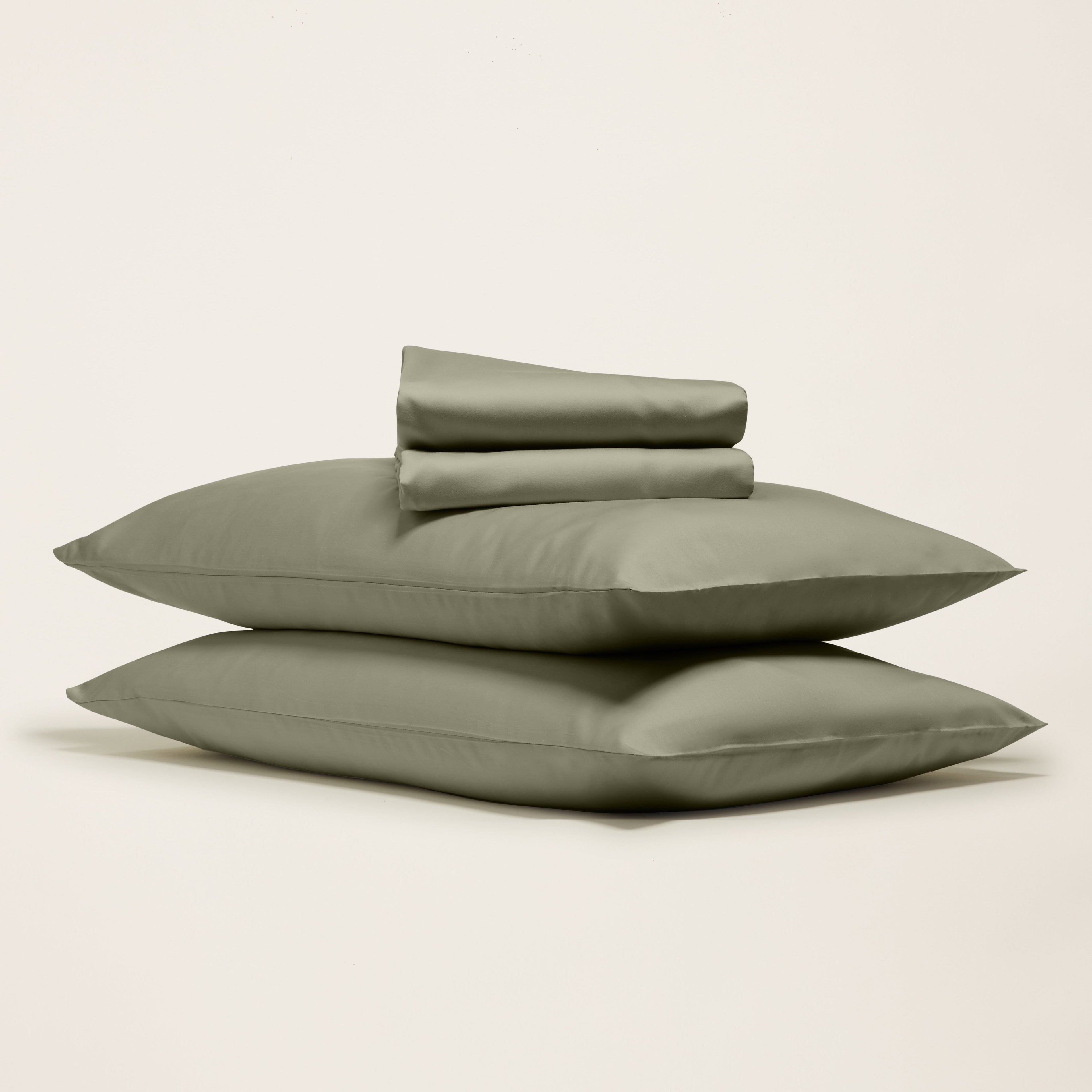 Smooth Luxe Australian Sateen Sheet Set by Italic shown on a neatly made bed with white satin sheets and matching pillowcases.