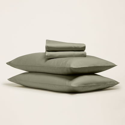 Smooth Luxe Australian Sateen Sheet Set by Italic shown on a neatly made bed with white satin sheets and matching pillowcases.