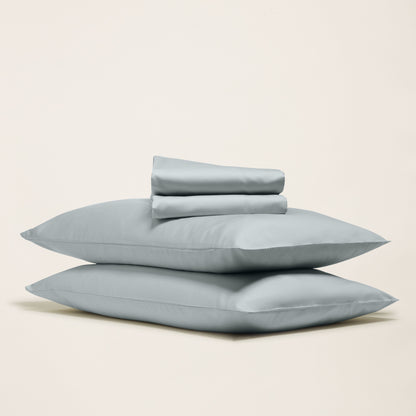 Italic Luxe Australian Sateen Sheet Set displayed on a bed with smooth, shiny, high-quality sateen fabric in a cozy home bedroom setting.