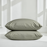 Smooth Luxe Australian Sateen Sheet Set by Italic with soft, shiny satin fabric and neatly made bed with matching pillowcases.