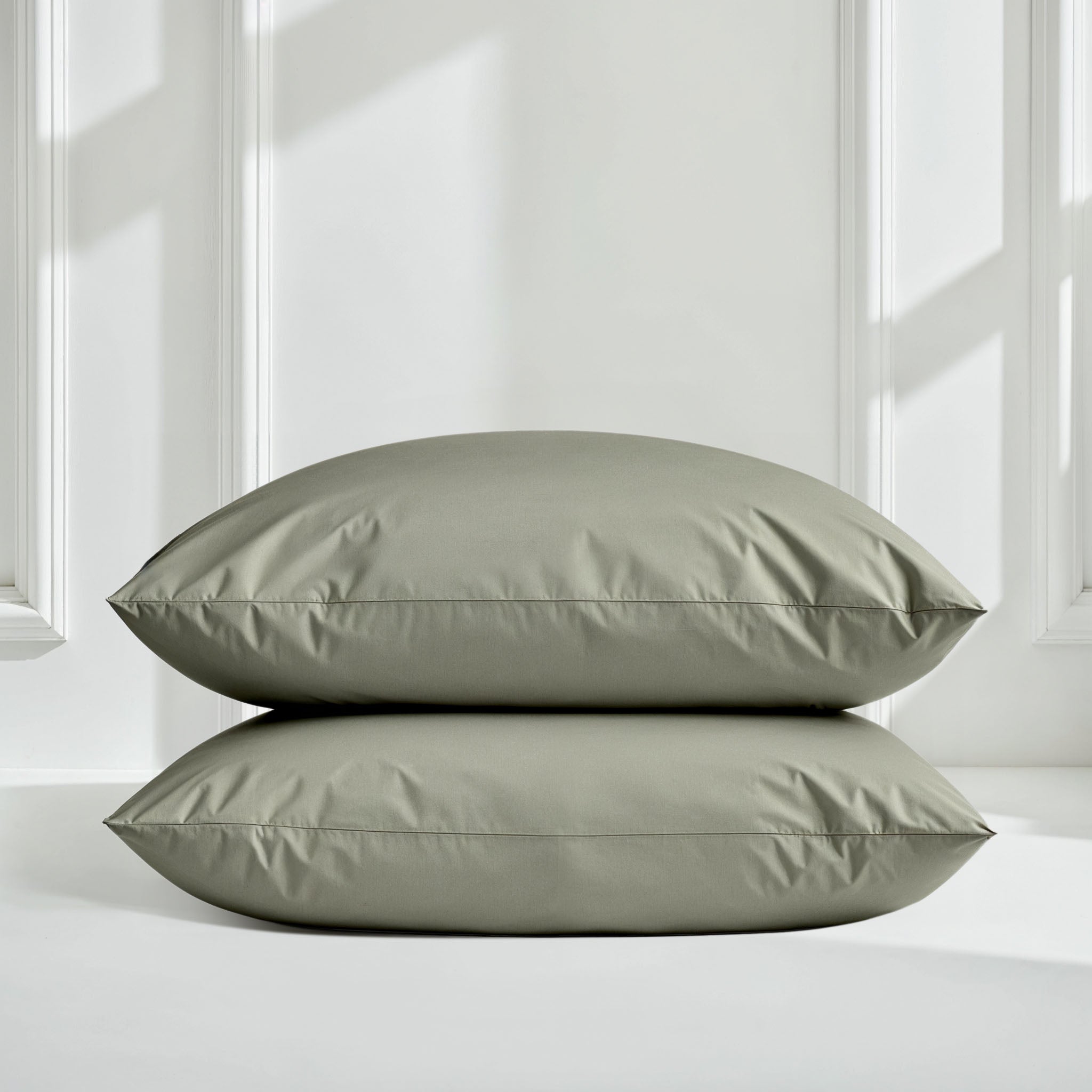 Smooth Luxe Australian Sateen Sheet Set by Italic with soft, shiny satin fabric and neatly made bed with matching pillowcases.