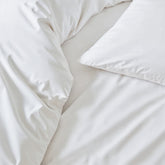 Soft beige Luxe Australian Sateen Sheet Set by Italic displayed on a neatly made bed with plush pillows.