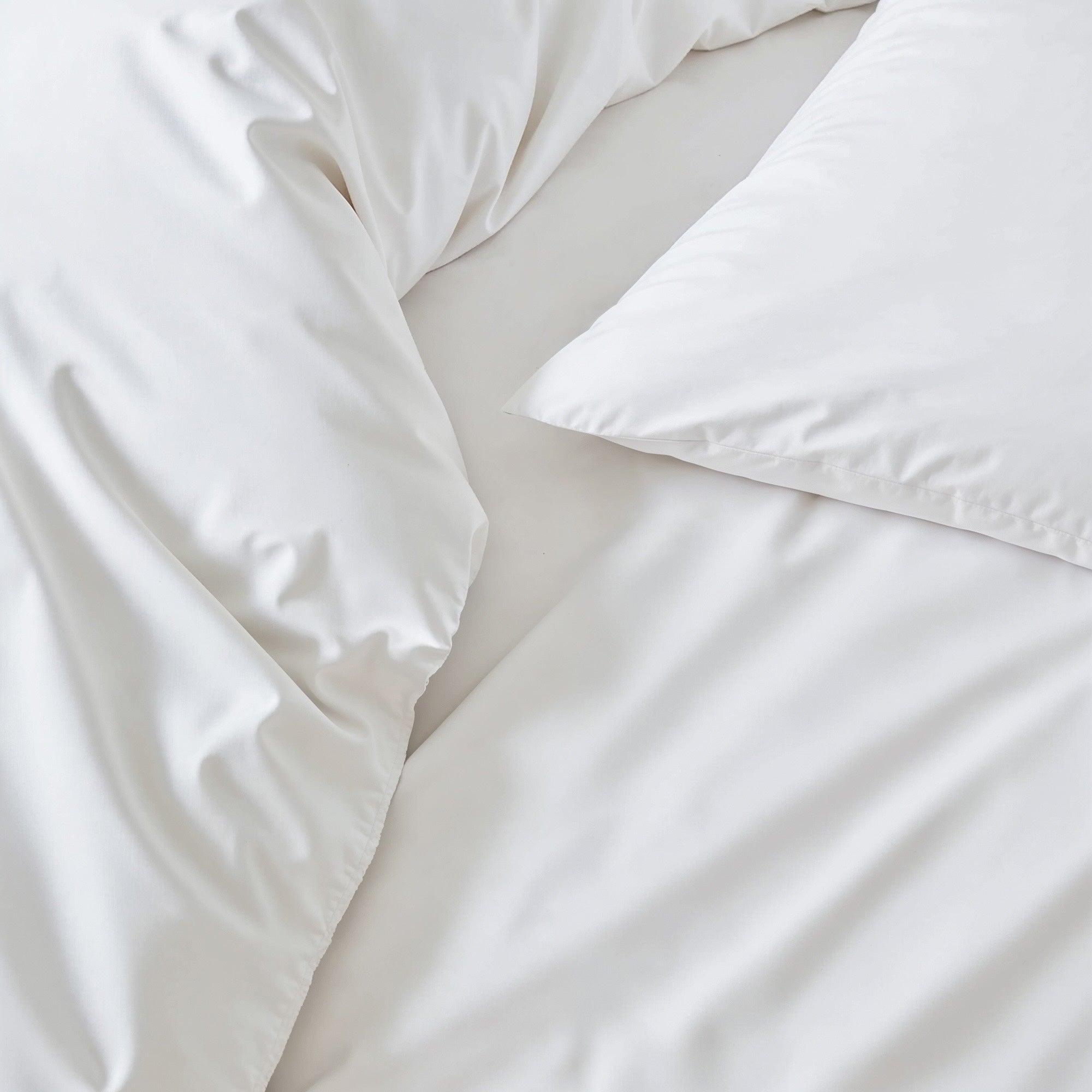Soft beige Luxe Australian Sateen Sheet Set by Italic displayed on a neatly made bed with plush pillows.