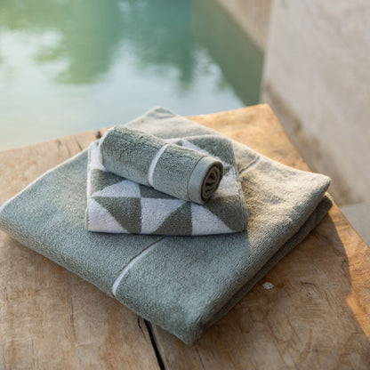 Soft white Deia Australian Cotton Towels from Italic displayed on a bed, showcasing plush texture and high-quality cotton fabric.