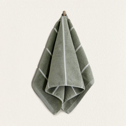 Soft white Deia Australian Cotton Towels from Italic, neatly folded on a bed for home use.
