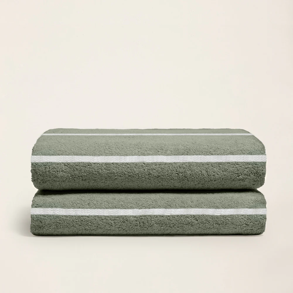 Soft Deia Australian cotton bath towel by Italic, shown draped on bed with plush texture and clean white appearance.