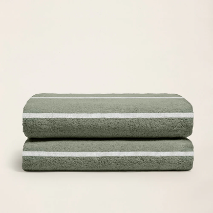 Soft Deia Australian cotton bath towel by Italic, shown draped on bed with plush texture and clean white appearance.