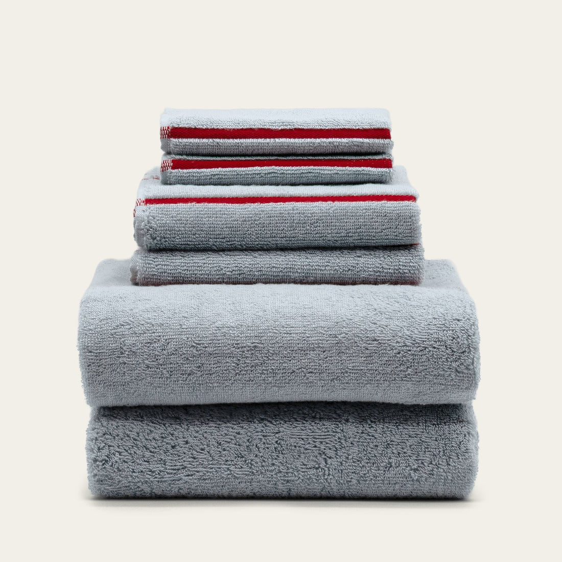 Soft white Deia Australian cotton bath towel from Italic, displayed on a bed with a textured weave and plush appearance.