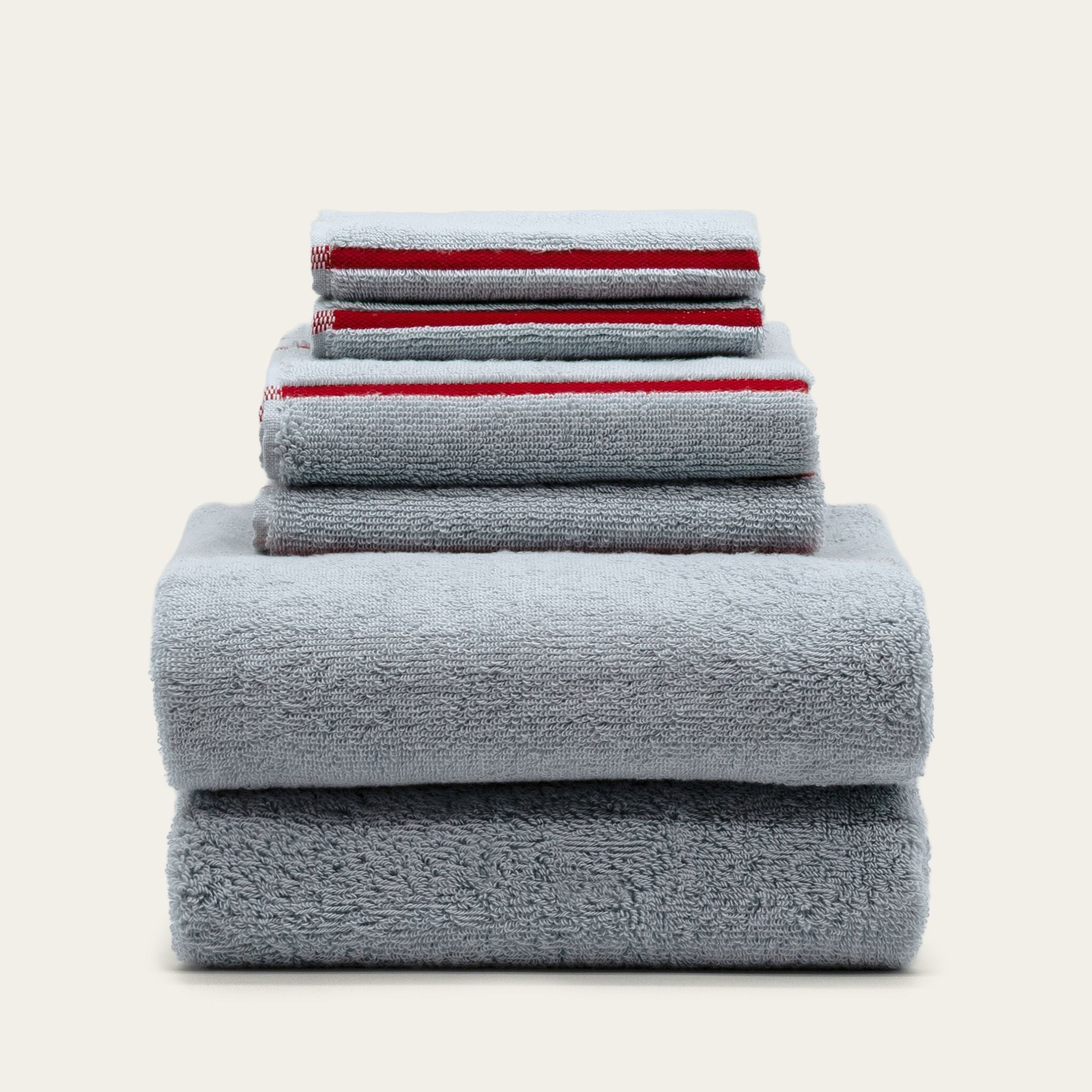 Soft white Deia Australian cotton bath towel from Italic, displayed on a bed with a textured weave and plush appearance.