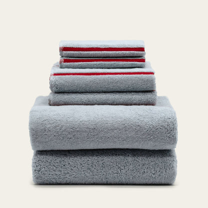 Soft white Deia Australian cotton bath towel from Italic, displayed on a bed with a textured weave and plush appearance.