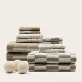 Set of Pietra Australian cotton towels in soft, neutral tones, featuring a textured weave, ideal for bathroom or guest use.