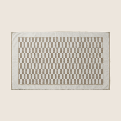 Italic Pietra Australian Cotton Towels flatlay with folded and draped towels showcasing soft, plush texture and neutral tones.