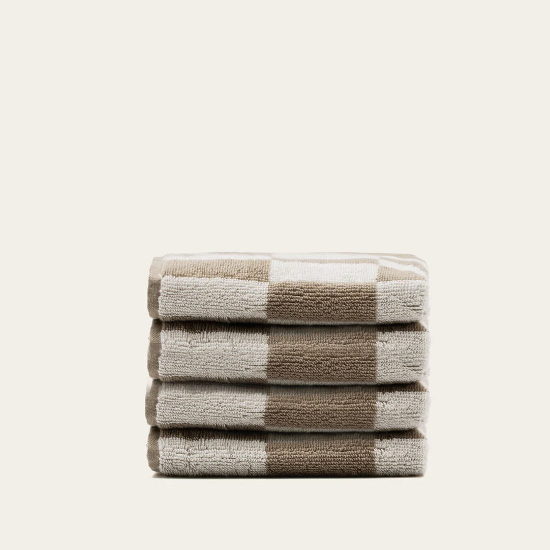 Set of four Pietra Australian Cotton Towels in tan, soft and plush with textured weave, by Italic.