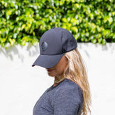 Black JOJU Performance UV Protective Sport Cap shown from front, highlighting its sleek design and adjustable strap.