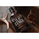 George T. Stagg Jr. Kentucky Straight Bourbon Whiskey bottle with label, 750ml, Liquor Geeks branding, dark glass bottle, and whiskey inside.