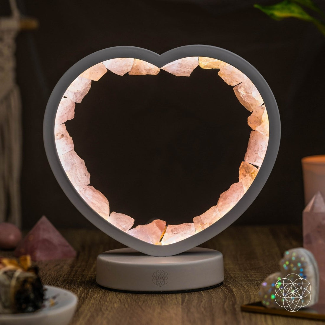 Rose quartz heart-shaped night light by Conscious Items, Love Magnet, emitting a soft glow and featuring a smooth, polished surface.
