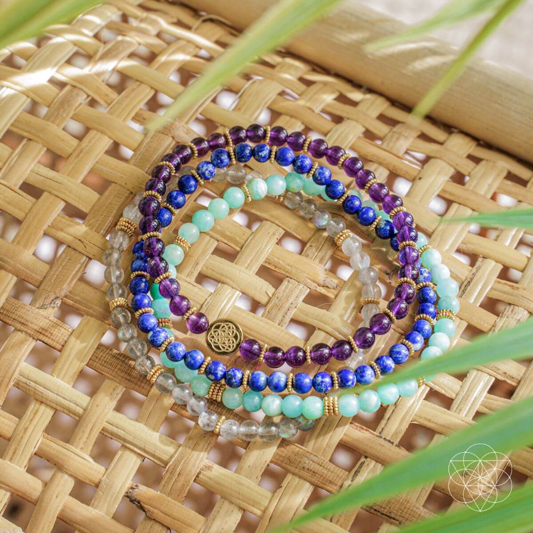 Set of four manifestation magnet jewelry pieces by Conscious Items, featuring spiritual and positive energy symbols.