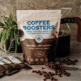 Unflavored collagen and electrolyte coffee boosters mixed into brewed coffee, enhancing flavor and health benefits.