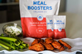 Classic Buffalo Collagen and Protein Blend powder from Meal Boosters, shown with a buffalo with wings in the background.