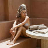 Model displaying a set of Italic Sorrel Australian Cotton Towels, showcasing their soft, plush texture and elegant design.