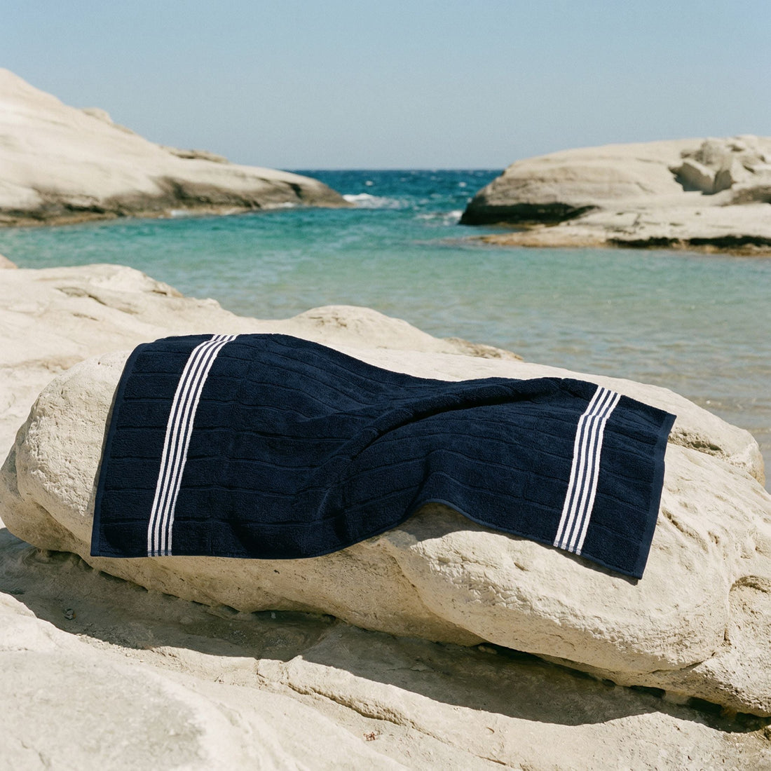 Nautilus Australian Cotton Bath Towel from Italic, soft white towel hanging on a bathroom hook, showcasing plush texture and quality.