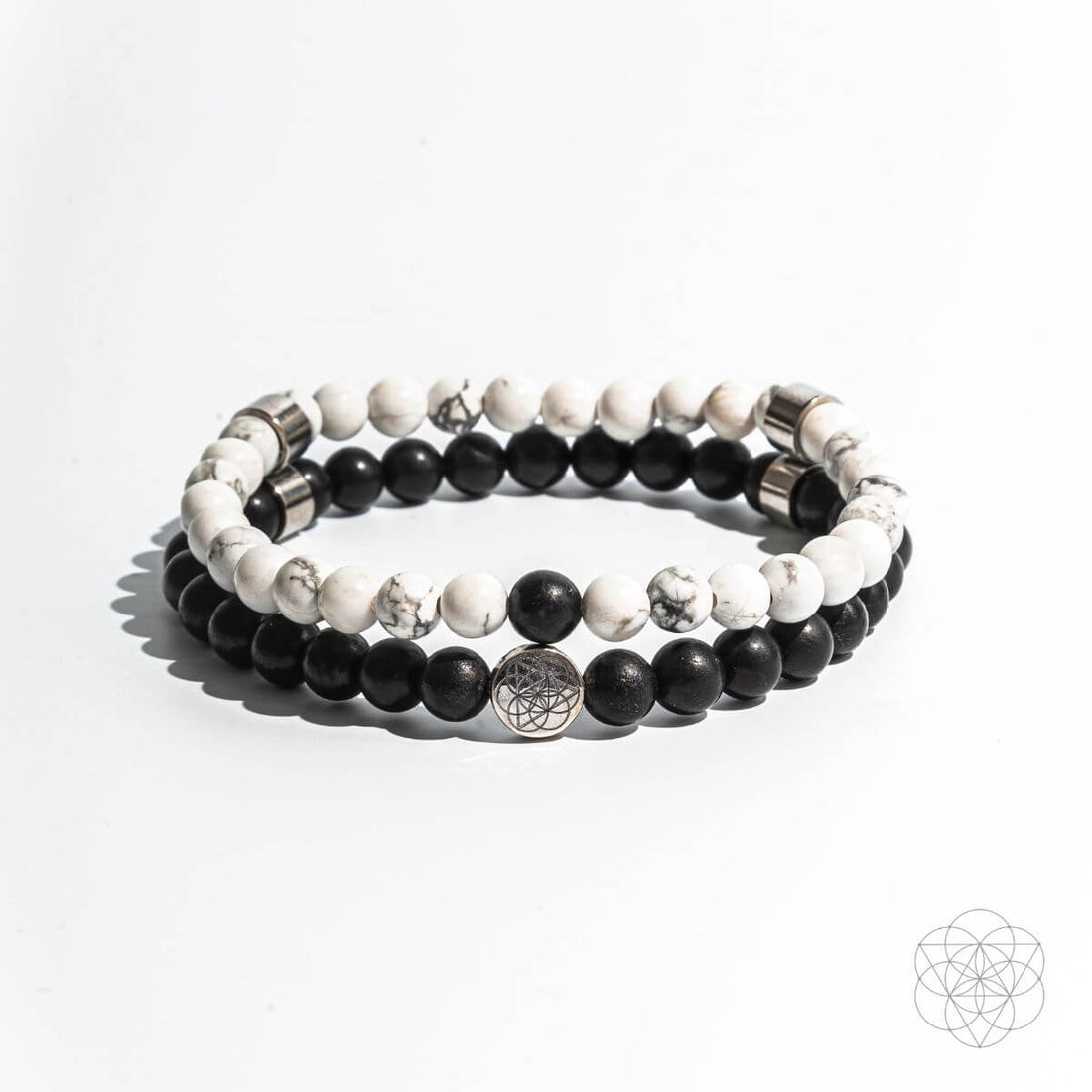 Set of Conscious Items jewelry featuring two negativity banisher bracelets with natural stones and adjustable cord designs.
