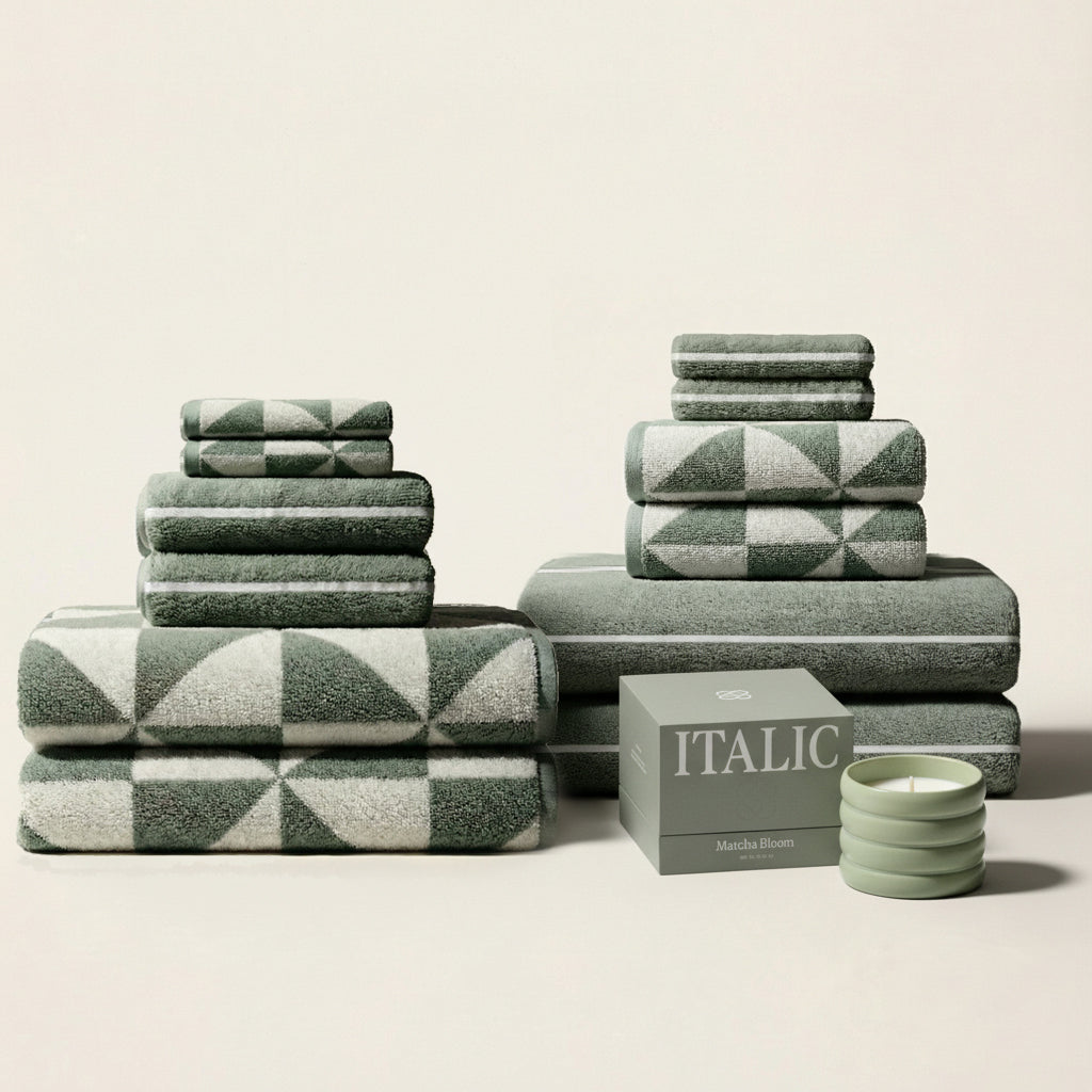 Soft white Deia Australian Cotton Towel from Italic, folded on a bed, showcasing plush texture and luxurious quality for home use.