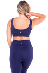 White Water Life open back sports bra with stylish design and supportive fit, shown in a vibrant athletic setting.